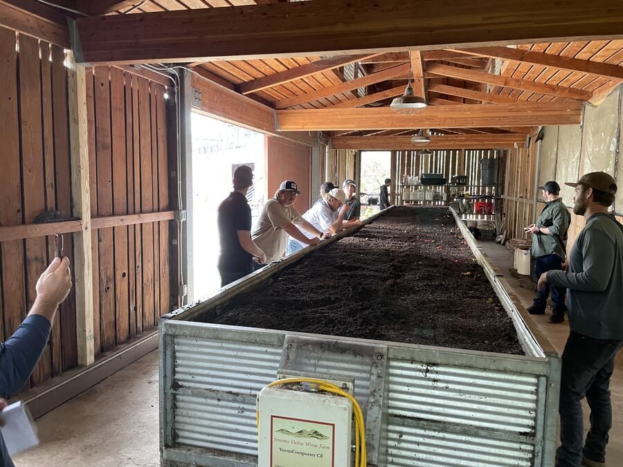 Students examining vermiculture system at Apricot Lane Farms — regenerative soil biology field study